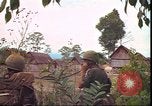 Image of thatched roof hut Pleiku South Vietnam, 1966, second 54 stock footage video 65675058783