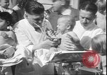 Image of chiropractors examining babies Los Angeles California USA, 1931, second 30 stock footage video 65675058948