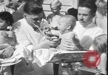 Image of chiropractors examining babies Los Angeles California USA, 1931, second 31 stock footage video 65675058948
