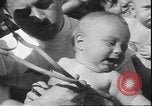 Image of chiropractors examining babies Los Angeles California USA, 1931, second 37 stock footage video 65675058948