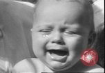 Image of chiropractors examining babies Los Angeles California USA, 1931, second 39 stock footage video 65675058948