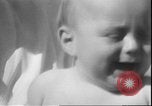 Image of chiropractors examining babies Los Angeles California USA, 1931, second 41 stock footage video 65675058948
