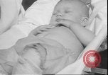 Image of chiropractors examining babies Los Angeles California USA, 1931, second 44 stock footage video 65675058948