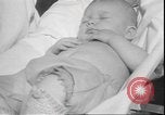 Image of chiropractors examining babies Los Angeles California USA, 1931, second 46 stock footage video 65675058948