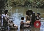 Image of Natives washing clothes in a river Leyte Philippines, 1945, second 3 stock footage video 65675059733