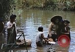 Image of Natives washing clothes in a river Leyte Philippines, 1945, second 6 stock footage video 65675059733