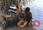 Image of Natives washing clothes in a river Leyte Philippines, 1945, second 12 stock footage video 65675059733