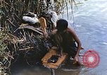 Image of Natives washing clothes in a river Leyte Philippines, 1945, second 13 stock footage video 65675059733