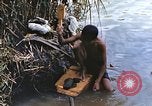 Image of Natives washing clothes in a river Leyte Philippines, 1945, second 15 stock footage video 65675059733