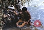 Image of Natives washing clothes in a river Leyte Philippines, 1945, second 16 stock footage video 65675059733