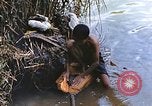 Image of Natives washing clothes in a river Leyte Philippines, 1945, second 17 stock footage video 65675059733