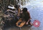 Image of Natives washing clothes in a river Leyte Philippines, 1945, second 18 stock footage video 65675059733
