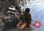 Image of Natives washing clothes in a river Leyte Philippines, 1945, second 19 stock footage video 65675059733