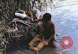 Image of Natives washing clothes in a river Leyte Philippines, 1945, second 20 stock footage video 65675059733