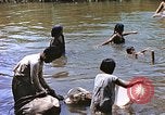 Image of Natives washing clothes in a river Leyte Philippines, 1945, second 21 stock footage video 65675059733