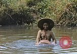 Image of Natives washing clothes in a river Leyte Philippines, 1945, second 34 stock footage video 65675059733