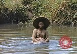Image of Natives washing clothes in a river Leyte Philippines, 1945, second 35 stock footage video 65675059733