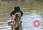 Image of Natives washing clothes in a river Leyte Philippines, 1945, second 42 stock footage video 65675059733