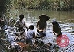 Image of Natives washing clothes in a river Leyte Philippines, 1945, second 46 stock footage video 65675059733
