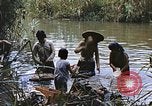 Image of Natives washing clothes in a river Leyte Philippines, 1945, second 47 stock footage video 65675059733