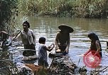 Image of Natives washing clothes in a river Leyte Philippines, 1945, second 50 stock footage video 65675059733