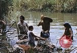 Image of Natives washing clothes in a river Leyte Philippines, 1945, second 51 stock footage video 65675059733