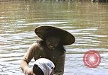 Image of Natives washing clothes in a river Leyte Philippines, 1945, second 52 stock footage video 65675059733