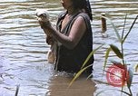 Image of Natives washing clothes in a river Leyte Philippines, 1945, second 59 stock footage video 65675059733