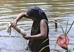 Image of Natives washing clothes in a river Leyte Philippines, 1945, second 61 stock footage video 65675059733