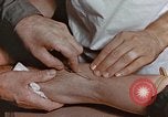 Image of wounded Marines Pacific Ocean, 1945, second 51 stock footage video 65675059750