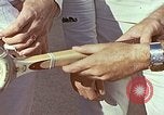 Standbild Tennis champion Bobbie Riggs demonstriert Schläger Grip Waikiki Hawaii USA, 1945, aus Sekunde 14 historischem Filmmaterial Videoclip 65675059779