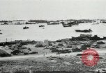 Immagine di Truppe alleate e attrezzature essendo portata a terra sulla spiaggia di Omaha Normandia Francia, 1944, secondo 12 filmato di repertorio 65675060099