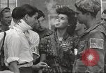 Image of U.S. Paratrooper talks with  French Forces of Interior Saint Tropez France, 1944, second 60 stock footage video 65675061547