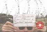 Image of view through barbed wire at airbase operations Vietnam, 1967, second 1 stock footage video 65675061936