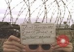 Image of view through barbed wire at airbase operations Vietnam, 1967, second 4 stock footage video 65675061936