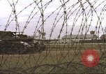 Image of view through barbed wire at airbase operations Vietnam, 1967, second 8 stock footage video 65675061936