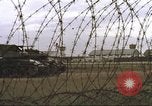 Image of view through barbed wire at airbase operations Vietnam, 1967, second 10 stock footage video 65675061936