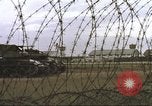 Image of view through barbed wire at airbase operations Vietnam, 1967, second 11 stock footage video 65675061936