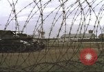 Image of view through barbed wire at airbase operations Vietnam, 1967, second 13 stock footage video 65675061936