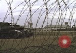 Image of view through barbed wire at airbase operations Vietnam, 1967, second 14 stock footage video 65675061936