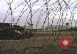 Image of view through barbed wire at airbase operations Vietnam, 1967, second 15 stock footage video 65675061936
