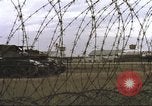 Image of view through barbed wire at airbase operations Vietnam, 1967, second 16 stock footage video 65675061936