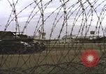 Image of view through barbed wire at airbase operations Vietnam, 1967, second 17 stock footage video 65675061936