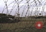 Image of view through barbed wire at airbase operations Vietnam, 1967, second 18 stock footage video 65675061936