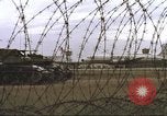 Image of view through barbed wire at airbase operations Vietnam, 1967, second 19 stock footage video 65675061936