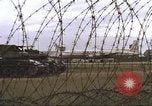 Image of view through barbed wire at airbase operations Vietnam, 1967, second 20 stock footage video 65675061936
