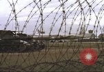Image of view through barbed wire at airbase operations Vietnam, 1967, second 21 stock footage video 65675061936