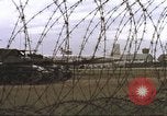 Image of view through barbed wire at airbase operations Vietnam, 1967, second 22 stock footage video 65675061936