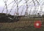 Image of view through barbed wire at airbase operations Vietnam, 1967, second 23 stock footage video 65675061936