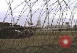 Image of view through barbed wire at airbase operations Vietnam, 1967, second 24 stock footage video 65675061936